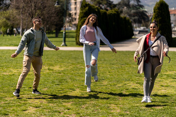 Dancing and jumping group of diverse friends on lawn