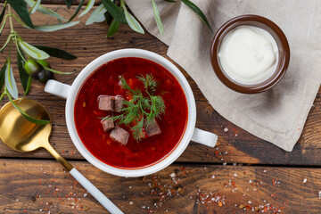 Borsch - Traditional Ukrainian / Russian soup on wooden background