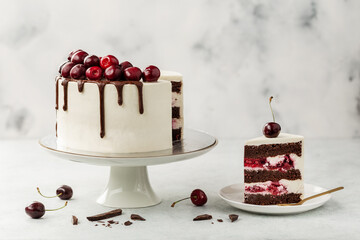 Cherry cake, Schwarzwald pie. White Cake, whipped cream, chocolate glaze and cherry on a light...