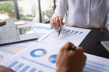 Cropped shot of bookkeeper coworkers working together in the boardroom, calculation brainstorming, discussing and analyzing, and planning business strategy.