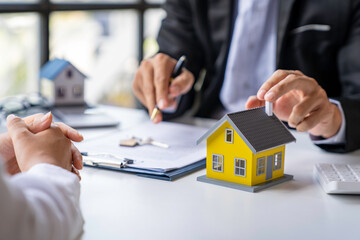 Fototapeta na wymiar Real estate agents offer home loan and insurance after discussing and signing an agreement with an approved application form. home insurance and real estate investment ideas