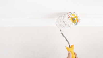 painting a white ceiling with a roller, home renovation.