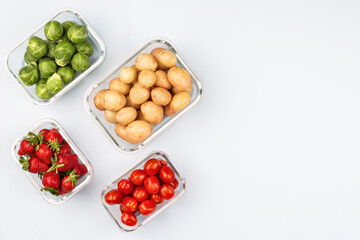 Glass boxes with fresh raw vegetables.  Vegetables and fruits in glass containers. Food storage concept