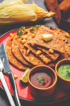 Sweet corn stuffed paratha or parotha served in a plate, Indian flatbread recipe made filling makai