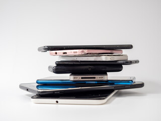 Old smartphones lie on top of each other. Smartphones on a white background.