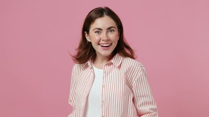 Side profile view young surprised woman 20s she wear shirt t-shirt turn around camera cover mouth with hands on face say wow omg no way isolated on plain pastel light pink background studio portrait