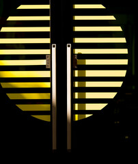 Double Doors with Yellow Parallel Lines on a Black Background.