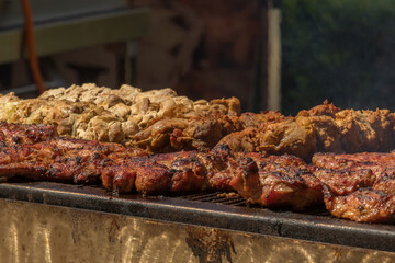 Grilled meat is grilled until golden brown. It is on the market counter.