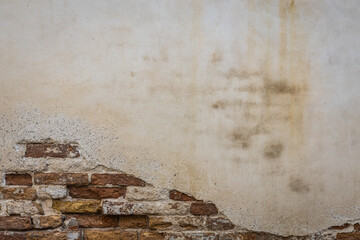 Brick and stucco wall background image that is weathered.