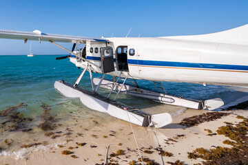 Cool old hydroplane with open door sitting on a sandy beach. Beautiful summer day in Dry Tortugas,...