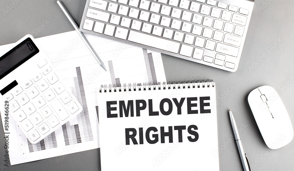 Poster employee rights text written on notebook on grey background with chart and keyboard , business conce