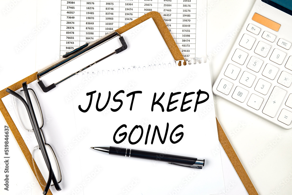Poster text just keep going on the white paper on clipboard with chart and calculator