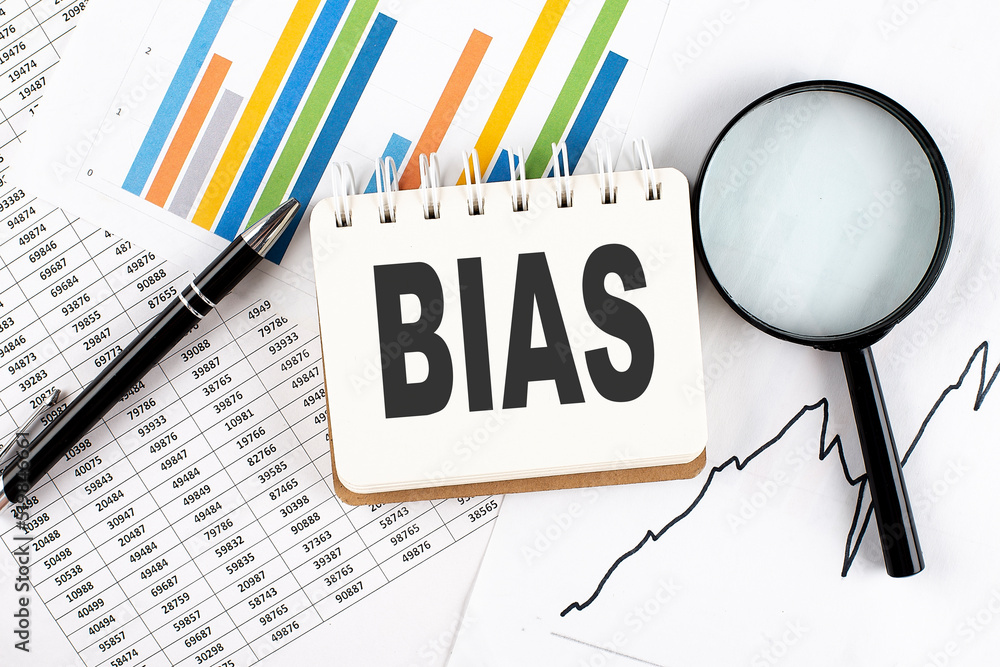 Poster bias text on notebook on the graph background with pen and magnifier