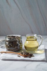 Sunflower oil, with seeds aside in a rustic setting.