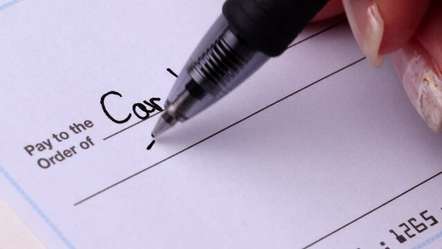 Close-up shot of a check being writen.