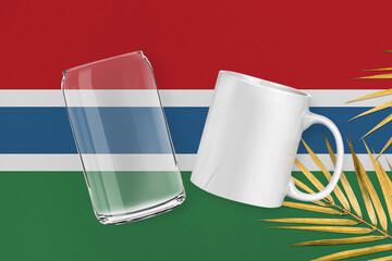 Patriotic can glass and mug mock up on background in colors of national flag. Gambia