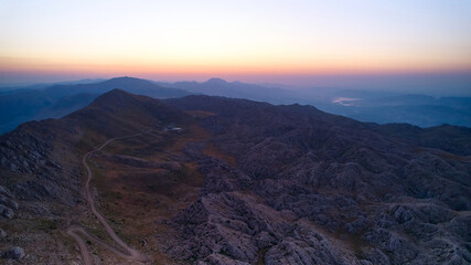 Aerial view of sun rising above Nemrut Mount and Taurus Mountains. Sunrise above Nemrut National park. UNESCO World Heritage Site. Adiyaman province, Turkey 