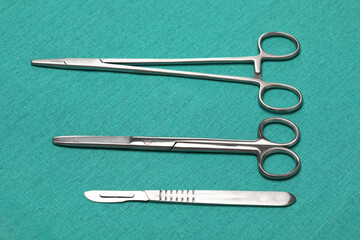 Sterile instruments on a green background close-up. Preparing instruments for surgery.