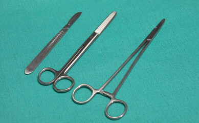 Sterile instruments on a green background close-up. Preparing instruments for surgery.