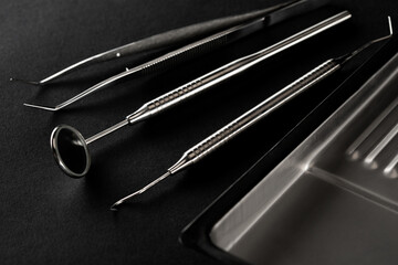 Dental tools on a black background close-up. Preparation of the dentist for the examination of the patient.