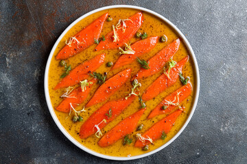 sockeye carpaccio with sauce on a white plate top view