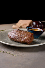 roast beef Steak with honey mustard sauce on plate on brown table