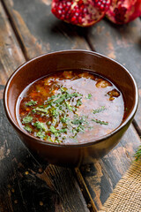 soup kharcho on bowl on old wooden table, georgian cuisine