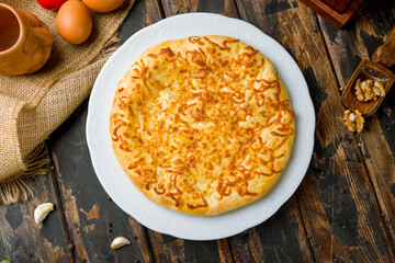 khachapuri with cheese, megrelian khachapuri, georgian cuisine on wooden table  top view