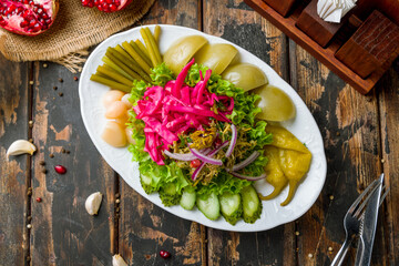 plate of georgian pickles on old wooden table