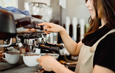 Asian woman professional barista using drip machine uniform to make hot coffee in the morning to serve customers with bright smiles, Concept small business SME, Entrepreneurship, Freelance Lifestyle.