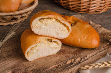 Appetizing fresh culinary pastry - pies with different fillings on a wooden