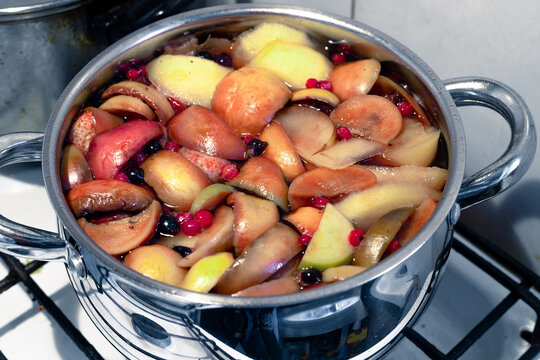 Freshly brewed fruit compote in a saucepan close-up