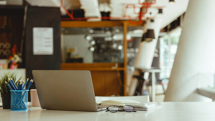 Laptop or notebook put on desk table of business workspace.