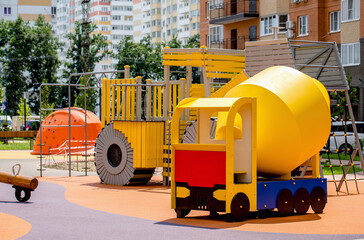 Modern playground in the courtyard of a multi-storey residential complex.