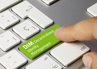 DIM Decentralized identity management - Inscription on Green Keyboard Key.