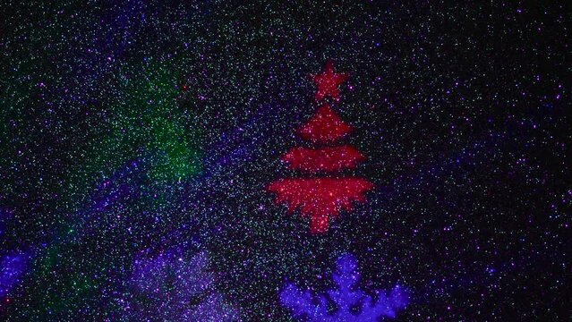 A carousel of light beams of different colors is set against a constantly flashing background that changes colors. Flying colored silhouettes of Christmas trees and snowflakes.
