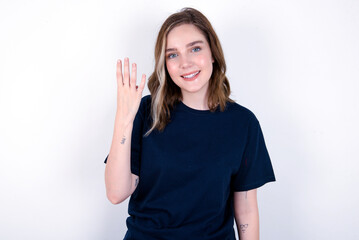 young caucasian woman wearing black T-shirt over white background smiling and looking friendly, showing number four or fourth with hand forward, counting down