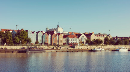 Szczecin waterfront with clear blue sky at dawn, retro color toning applied, Poland.