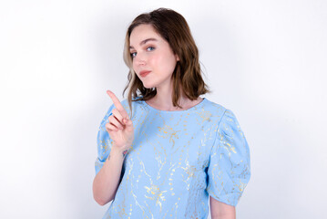 No sign gesture. Closeup portrait unhappy young caucasian woman wearing blue T-shirt over white...