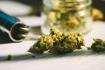 Obraz na płótnie Canvas Close up of medical marijuana or cannabis flower buds and lighter.