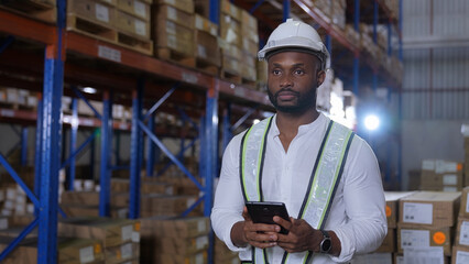 Business concept of 4k Resolution. African man checking goods in warehouse. Data collection of...