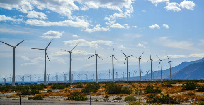 View of wind turbines generating electricity. Huge array of gigantic wind turbines spreading over the desert in Palm Springs wind farm, California