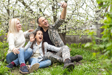 Soldier reunited with his family in park.