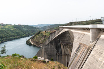 Concrete structure with arch of Aguieira dam with valley between the banks with Mondego river,...