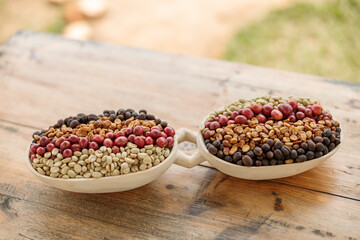 Close up of coffee beans of different processing processes in a wooden bowl