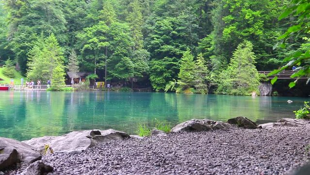 Blausee lake or Blue Lake during rain in Bernese Oberland, Kandergrund, Switzerland