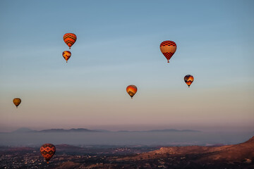 Many Hot air balloons over the Teotihuacan city in Mexico during sunrise