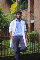 South asian medical student in white apron, Bangladeshi young confident doctor in uniform 