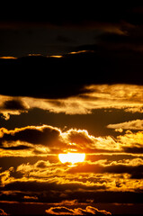 Sunset. When the sun, so close, big, crimson red, fantastically beautiful, saying goodbye to a summer day, gently gives the last warm rays.