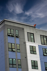 office building with windows/man on roof